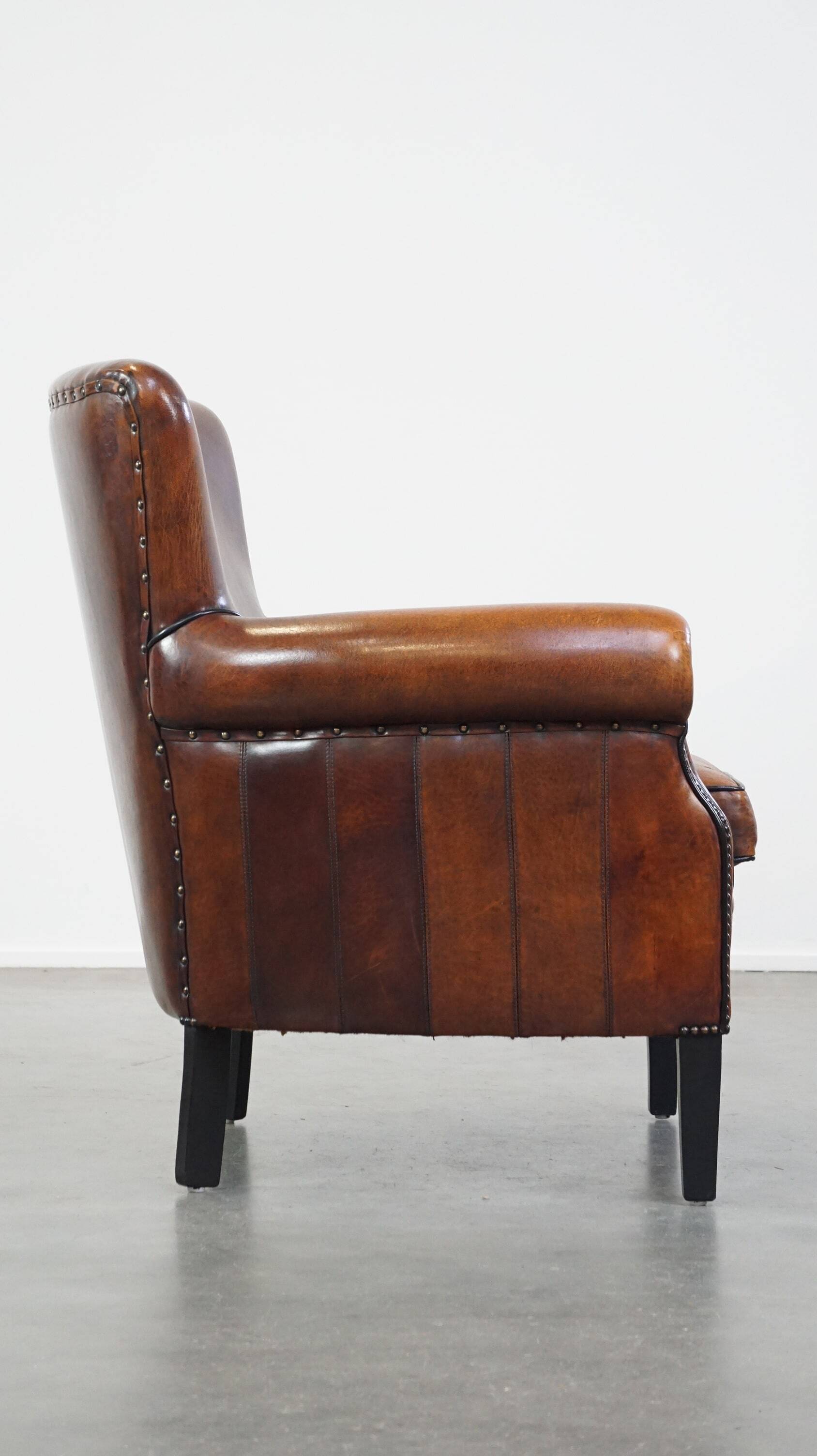 Sheepskin armchair/lounge chair finished with decorative nailheads