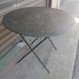Old folding garden table in wrought iron