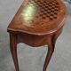 Half-moon gaming table in Louis XV style, made of precious wood marquetry.
