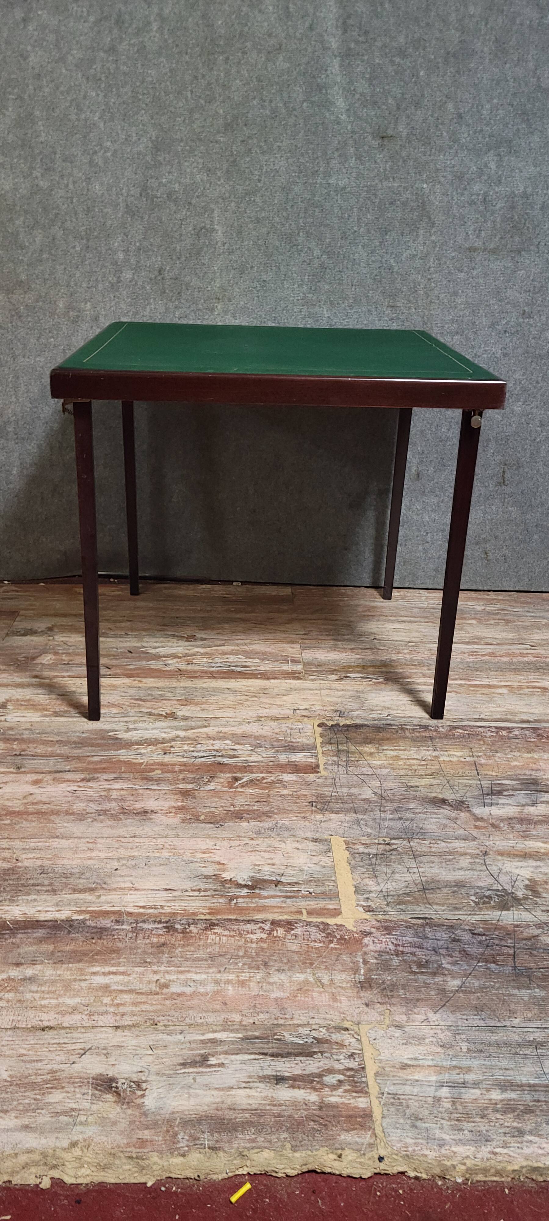 a wooden Bridge game table resting on four thin, straight legs