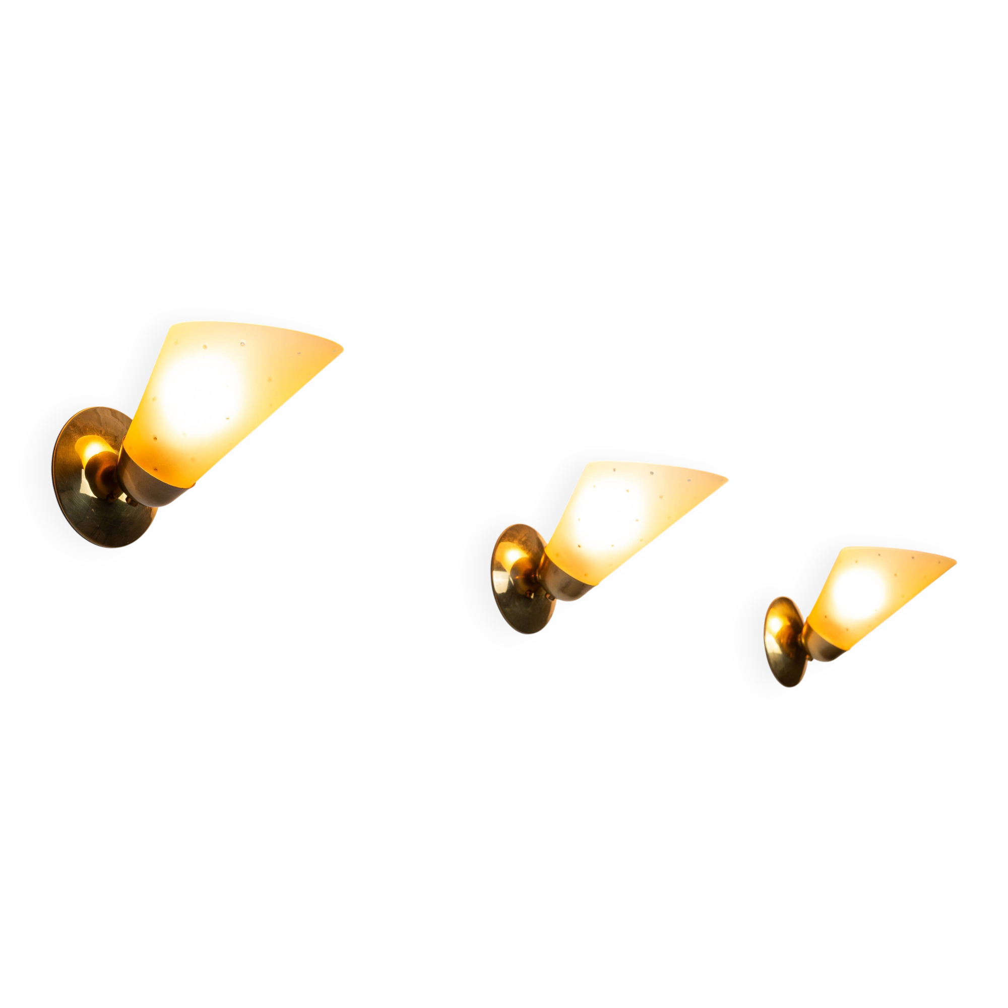 Set of three brass sconces with decorated yellow glass shades