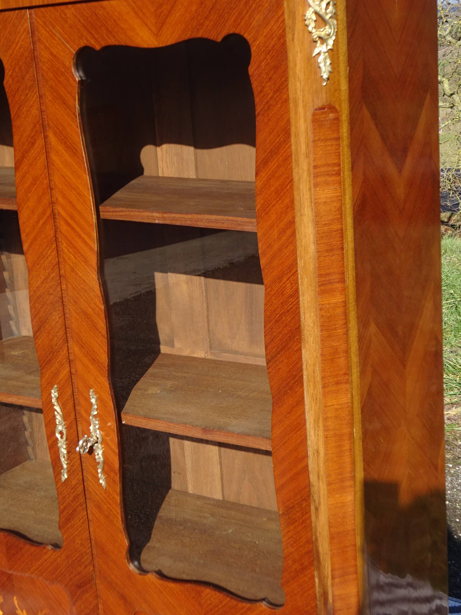 Glass library with rosewood marquetry in the Louis XV style.