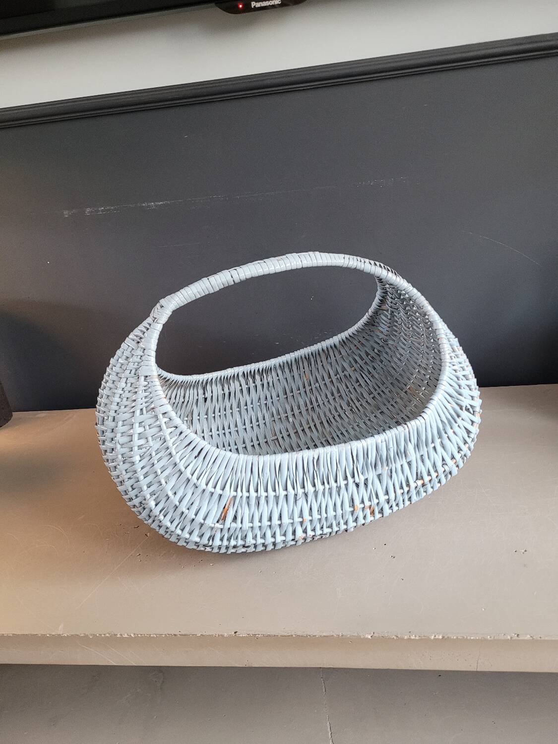 Turquoise-painted wicker basket