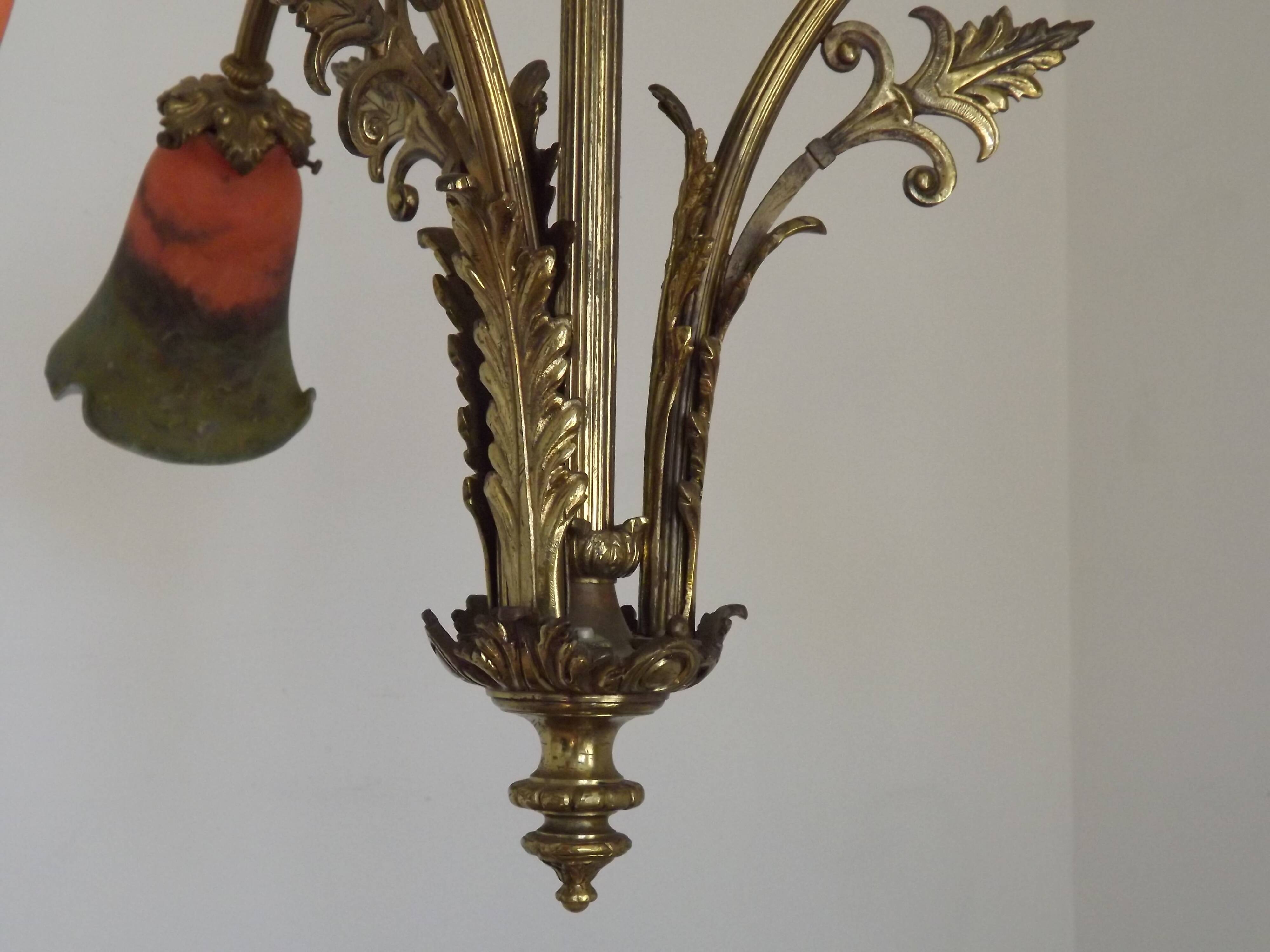 Art Nouveau three-light chandelier in bronze with orange and green glass shade, France.