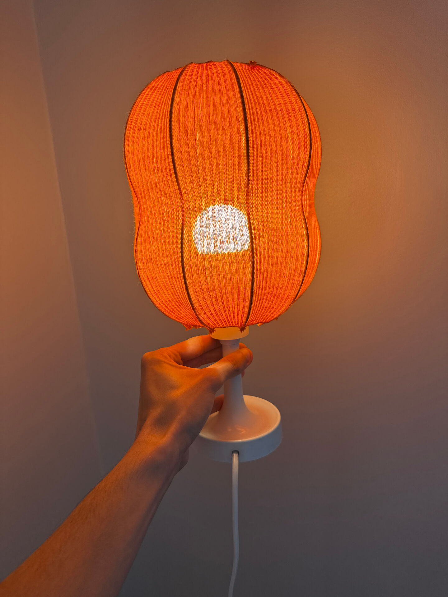 Lamp with a plastic base and a coloured fabric shade in Mid Century style.