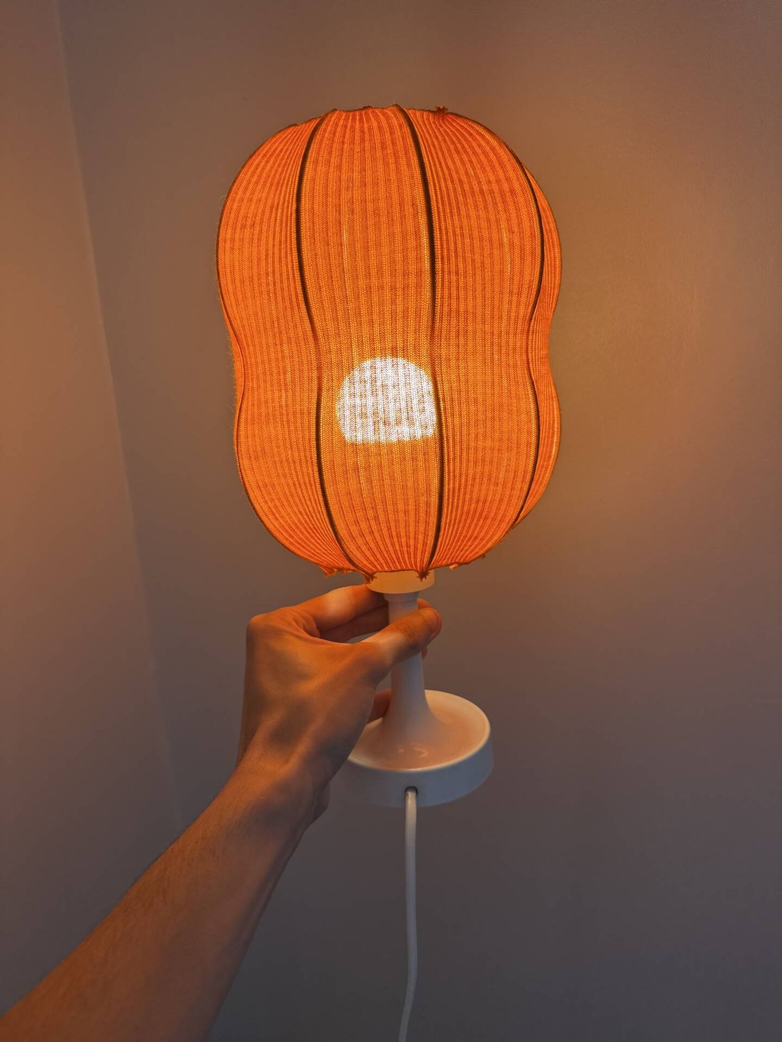 Lamp with a plastic base and a coloured fabric shade in Mid Century style.