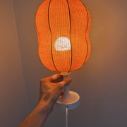 Lamp with a plastic base and a coloured fabric shade in Mid Century style.
