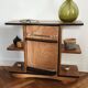 Compact bar cabinet with a pivoting door in black wood.