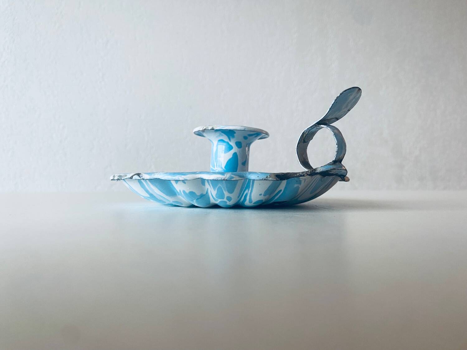 Old blue enameled metal candle holder