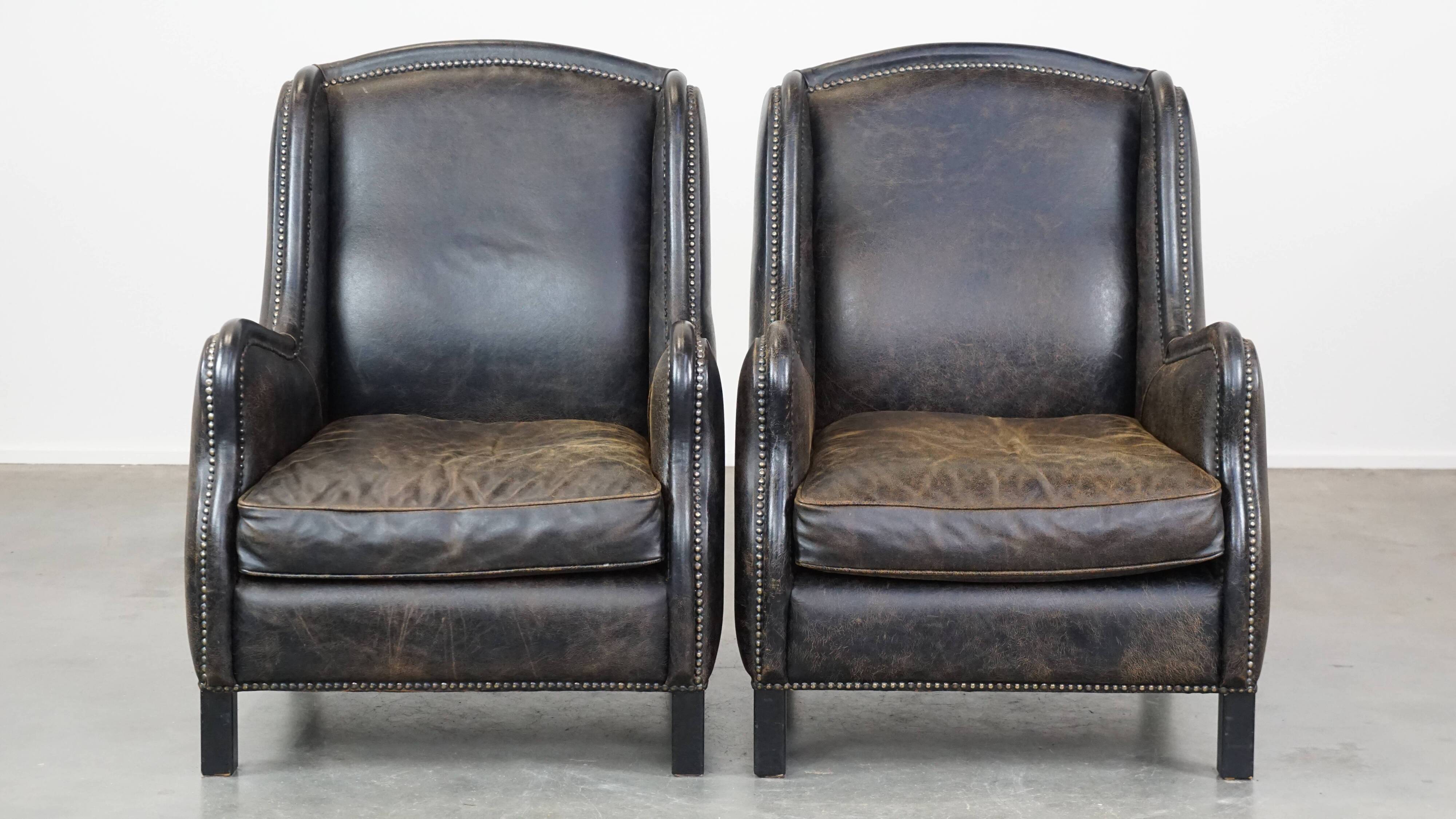 Set of 2 black cow leather armchairs finished with decorative nails, industrial style