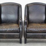 Set of 2 black cow leather armchairs finished with decorative nails, industrial style