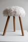 Danish mid-century tripod stool in beech, reupholstered in lambswool, 1960s.