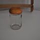 Brown wooden wall spice rack with a set of 6 glass jars, 1950s vintage style.