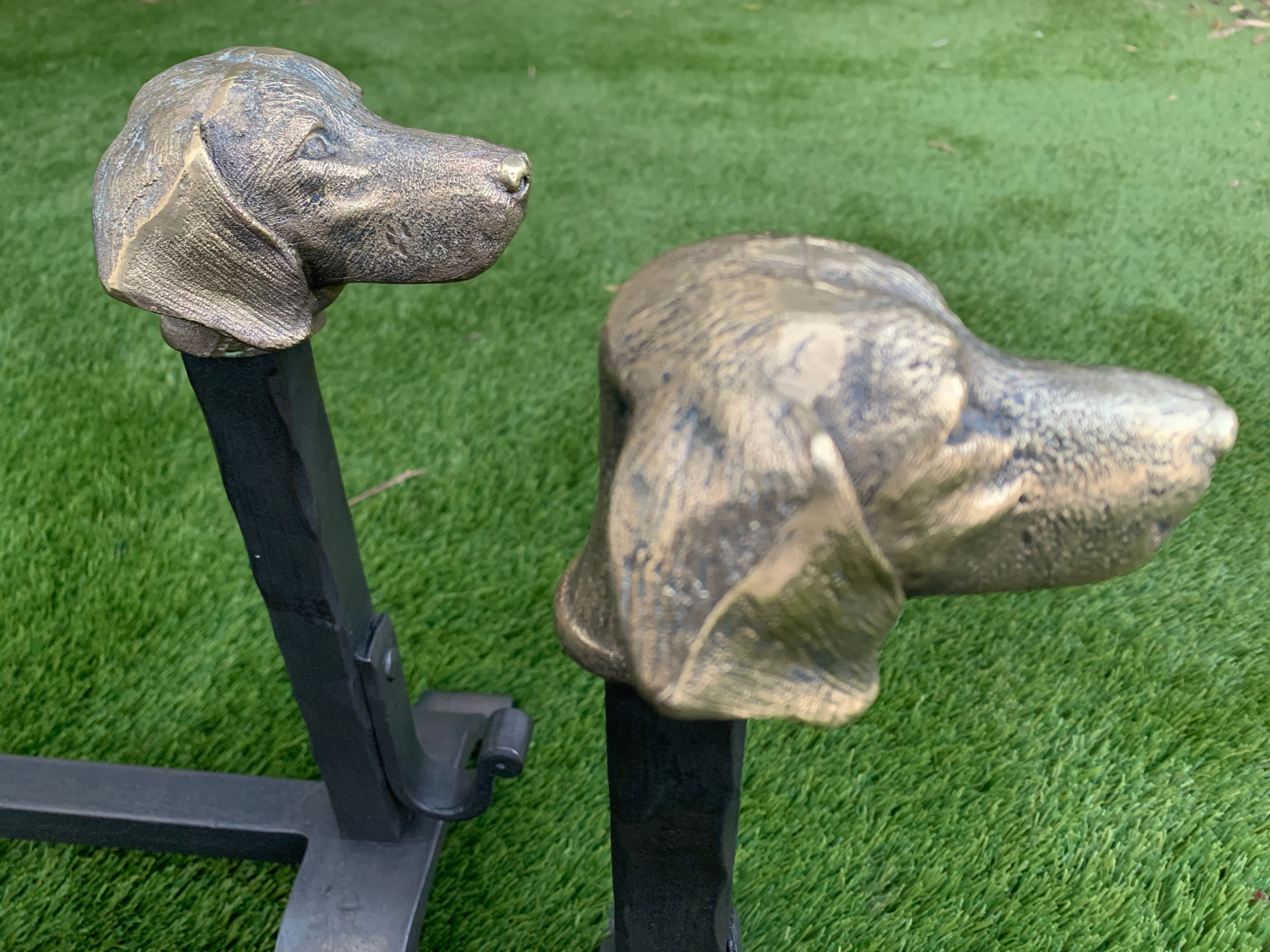 Pair of metal chenets decorated with brass dog heads