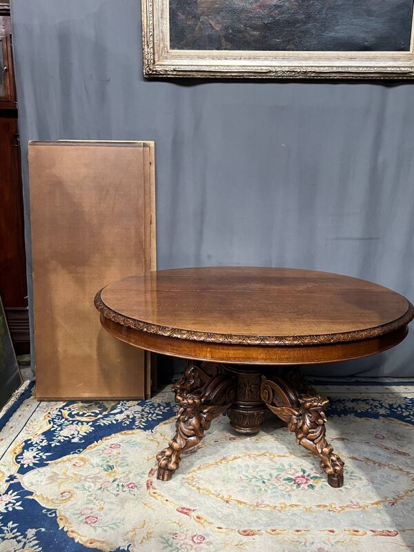Grande table à manger extensible de style chasse avec quatre figures de renard sur le pied.