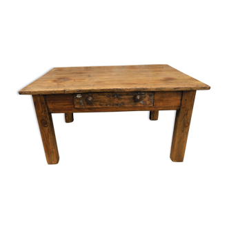 Old wooden coffee table with a central drawer