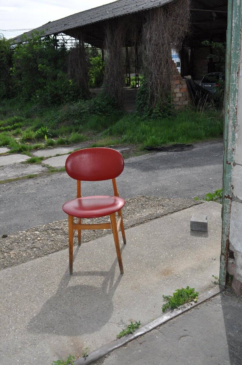 Vintage red office chair in faux leather and wood, 1960s Central European style.