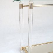 Hollywood Regency console table in lucite, glass and gold metal. 1980s