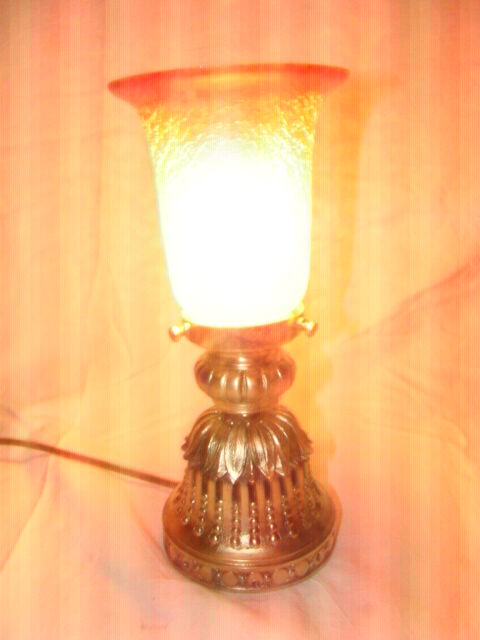 bronze bedside lamp with a pink cracked glass shade