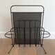 Black lacquered metal and perforated metal magazine rack designed by Mathieu Matégot 50.