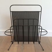 Black lacquered metal and perforated metal magazine rack designed by Mathieu Matégot 50.