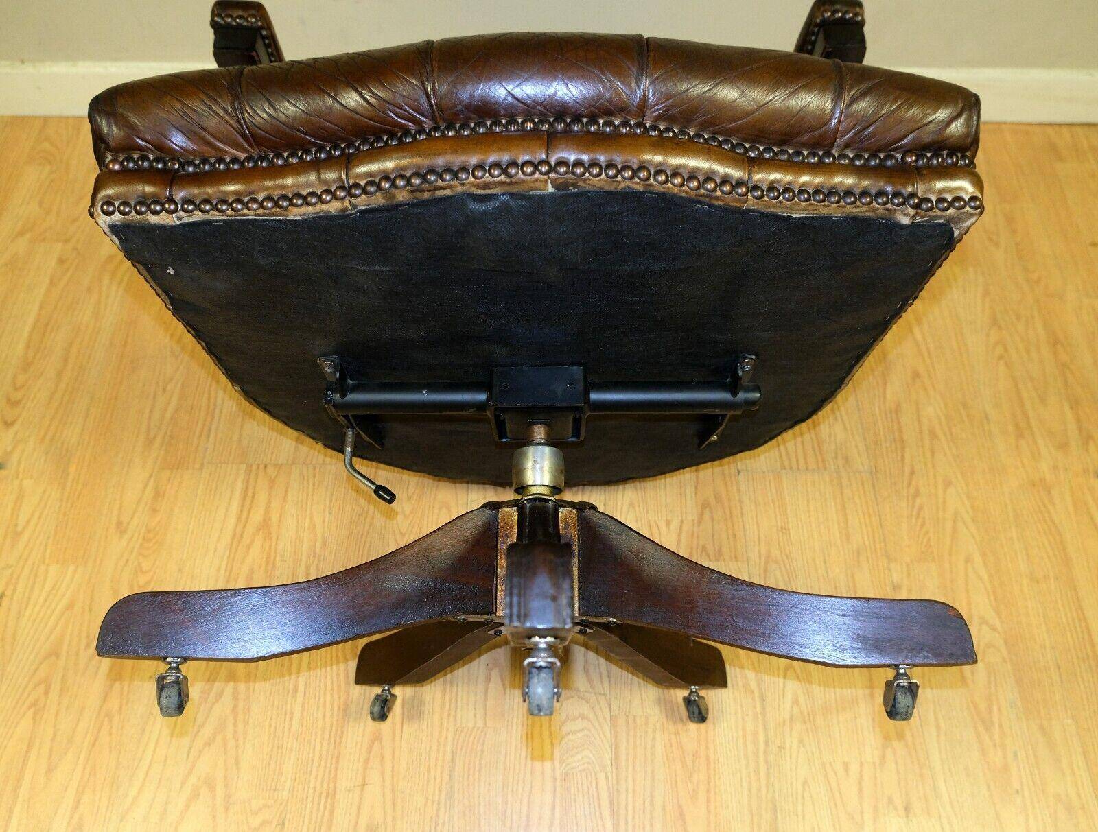 Restored Chesterfield captain's armchair in leather with an oak frame.