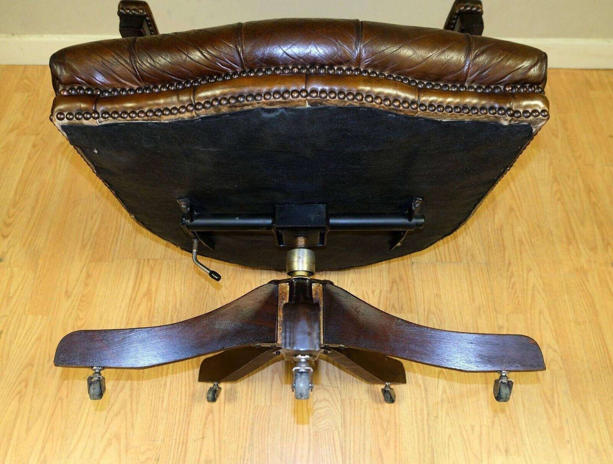 Restored Chesterfield captain's armchair in leather with an oak frame.