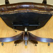 Restored Chesterfield captain's armchair in leather with an oak frame.