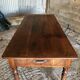 Antique Louis Philippe style farm table in solid cherry wood with turned base.
