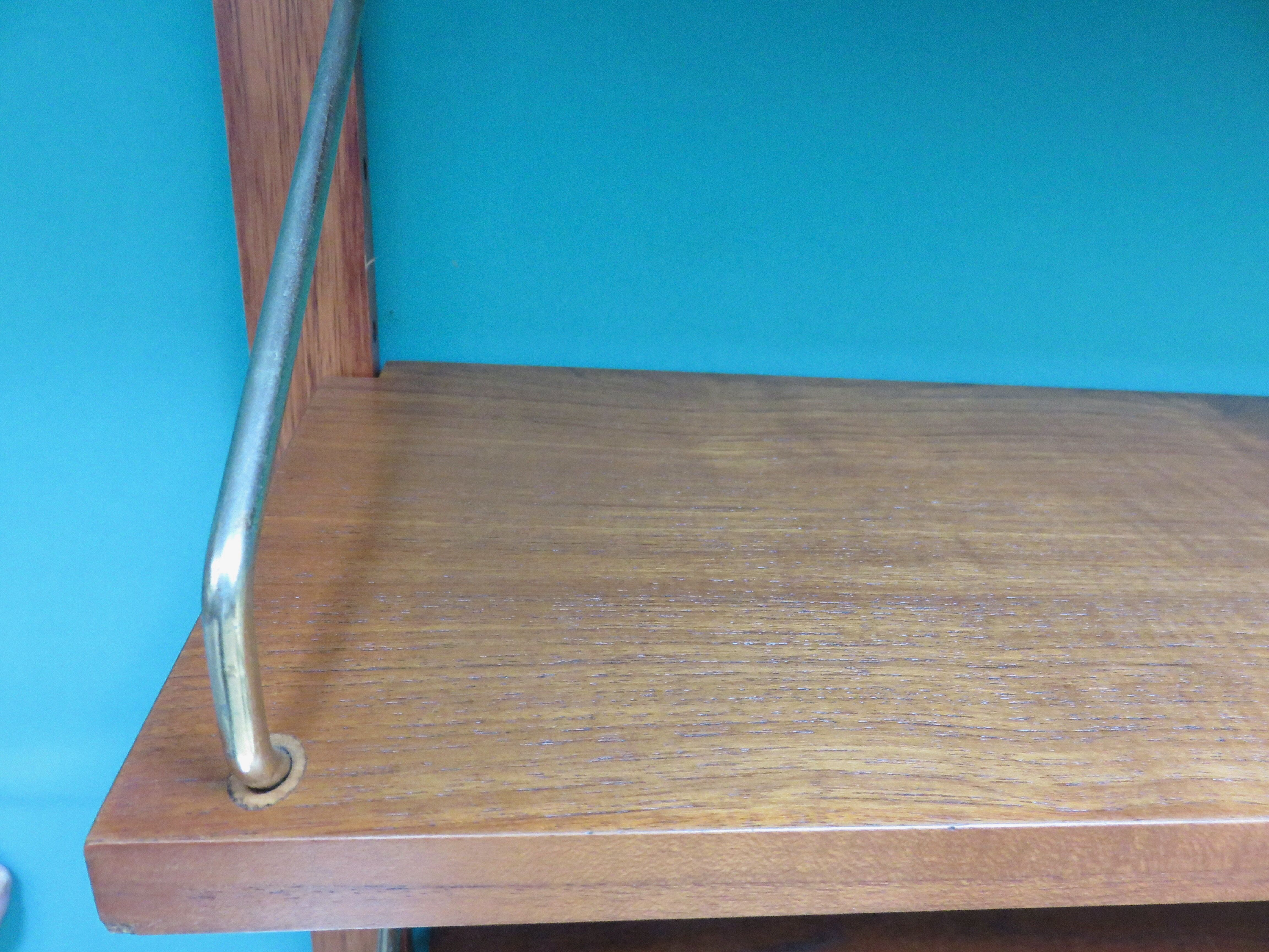 Wall shelving system and teak writing box. of Poul Cadovius. Denmark 1960