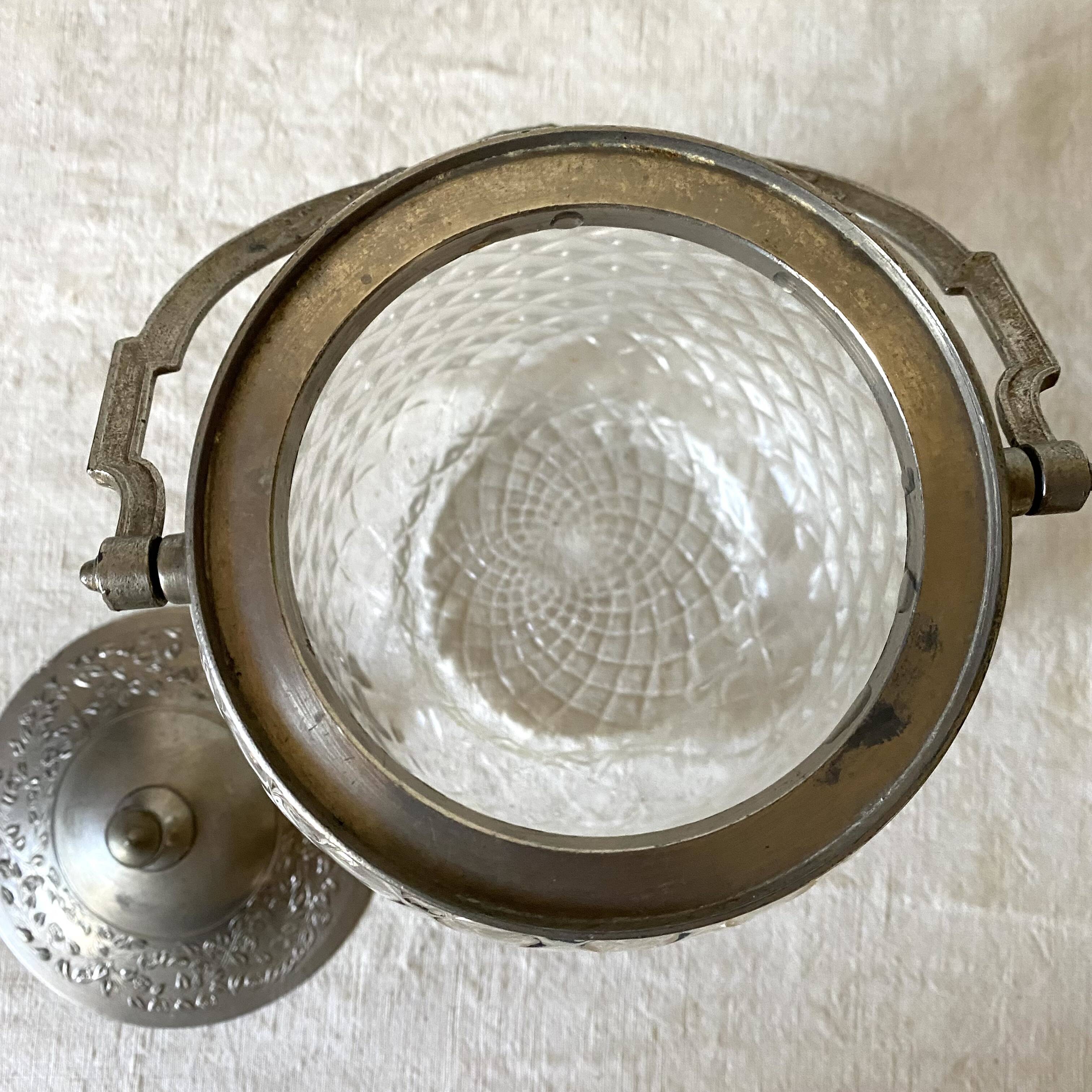 Old biscuit bucket in glass and metal
