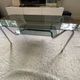 Double top coffee table in smoked glass and tubular structure in chromed steel