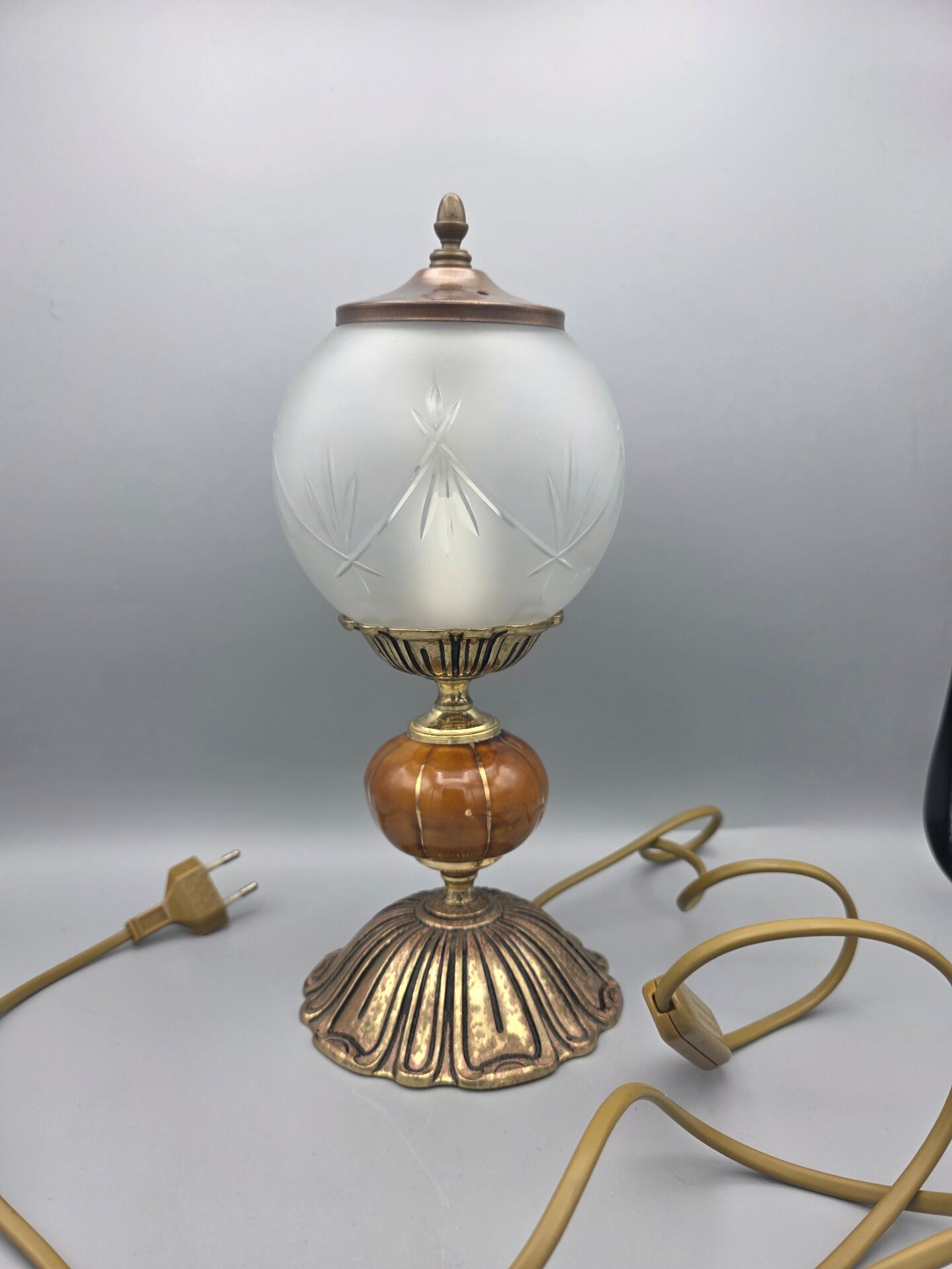 Hollywood Regency bedside lamp in gold metal with a glass globe.