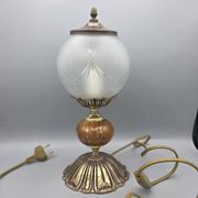 Hollywood Regency bedside lamp in gold metal with a glass globe.