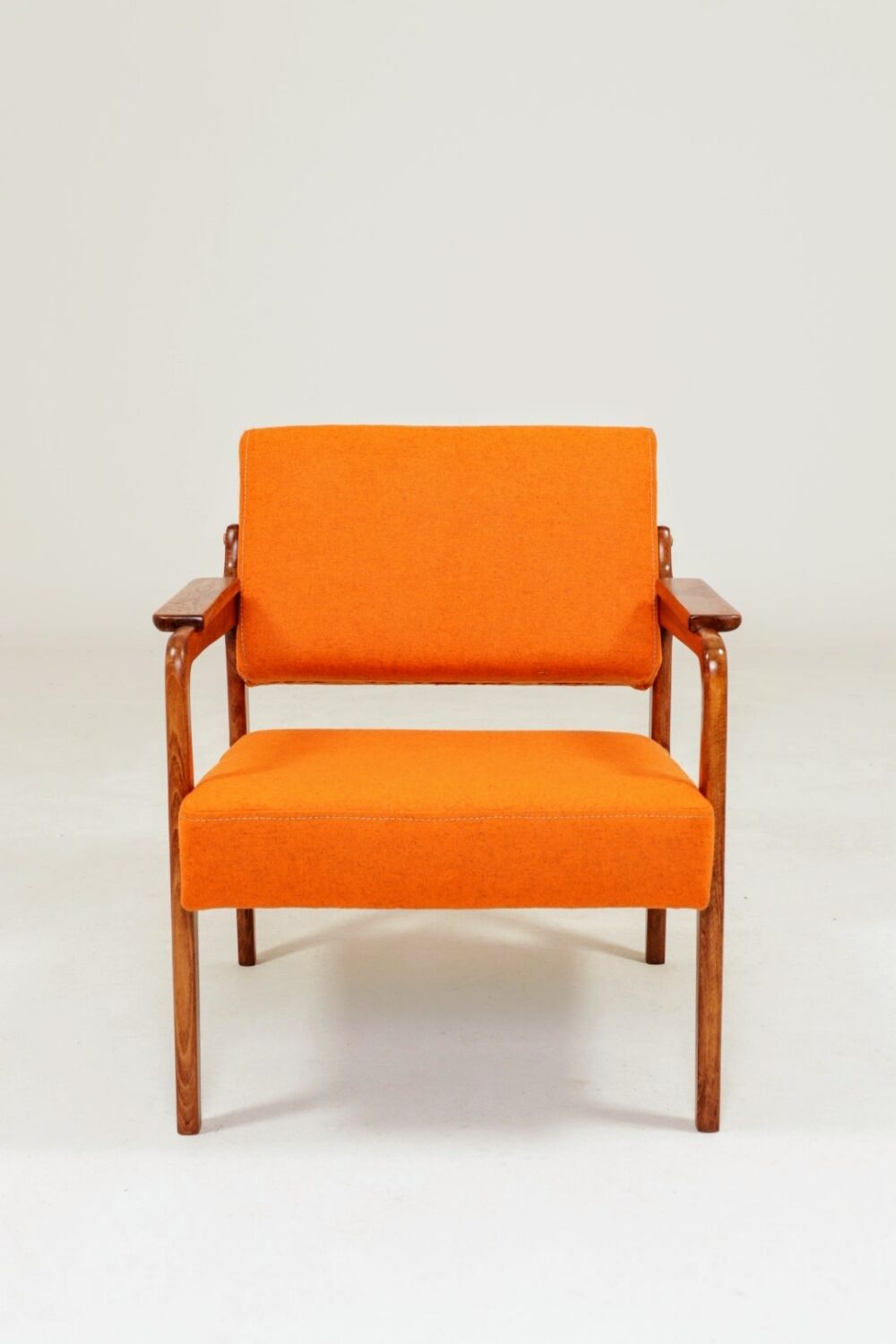 Vintage armchair in papaya orange wool from the 1960s.
