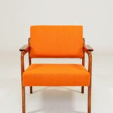 Vintage armchair in papaya orange wool from the 1960s.