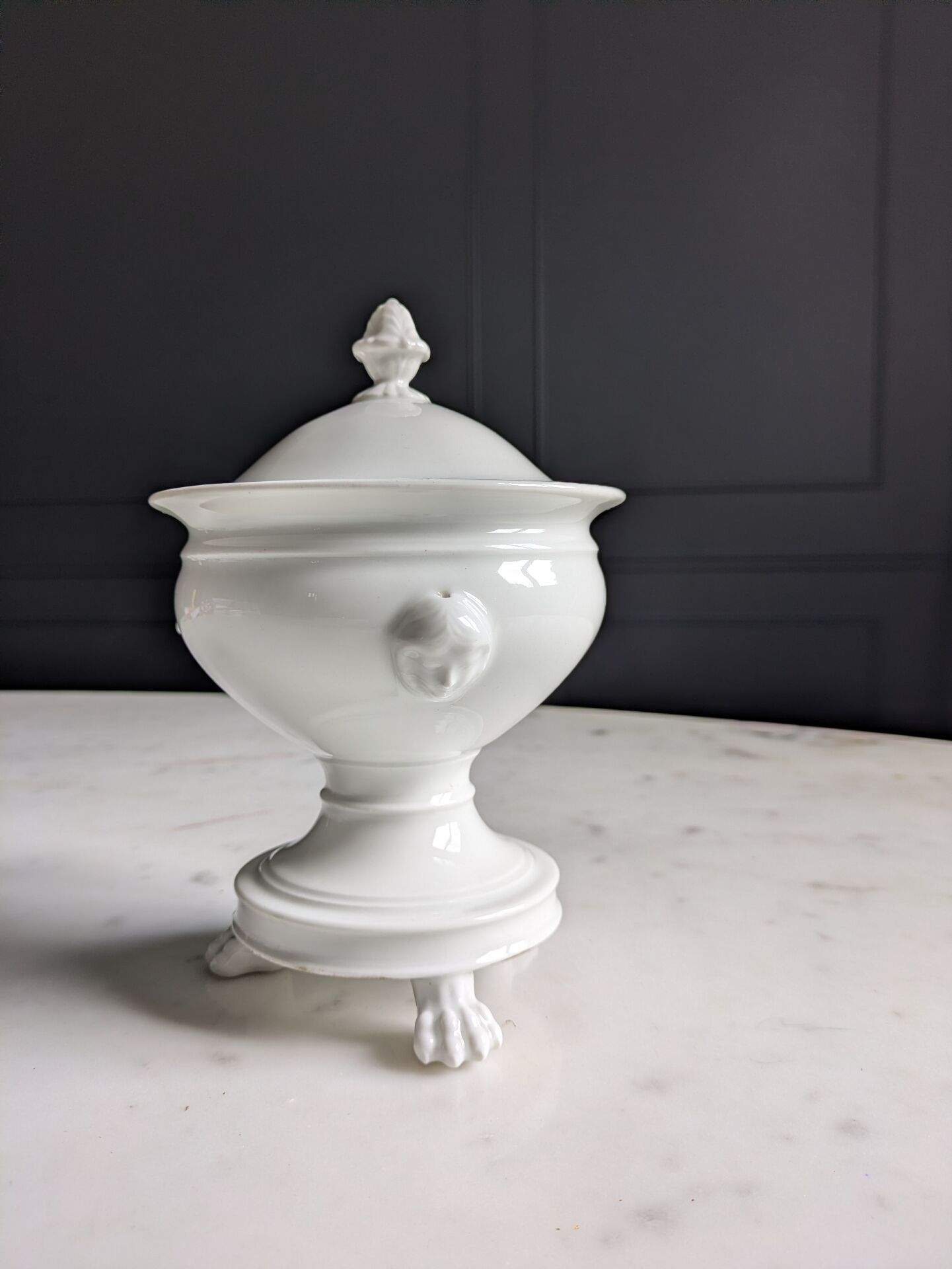 White porcelain confiturier with lion paws and masks. 19th century.