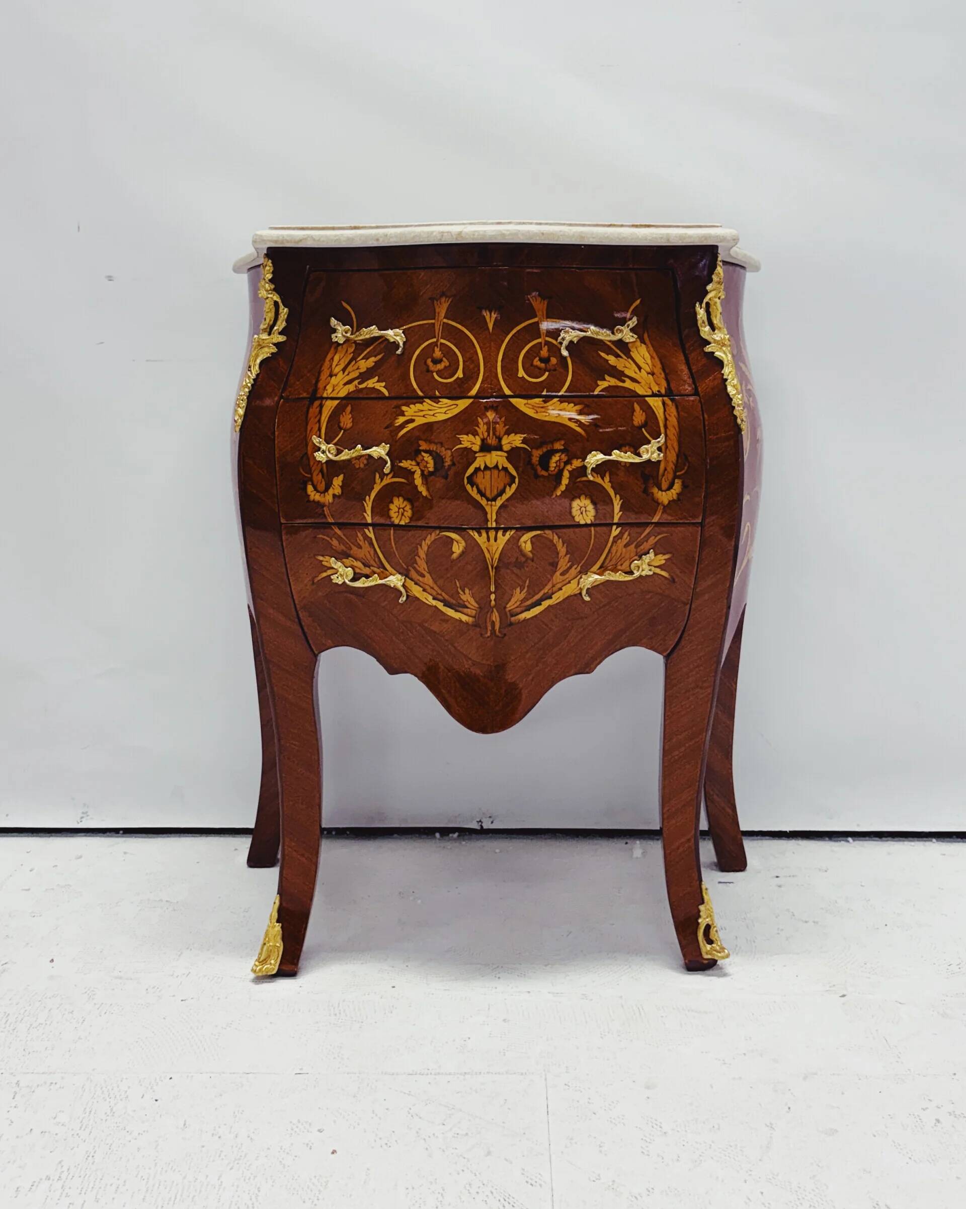 Marquetry chest of drawers with marble top in Louis XV style
