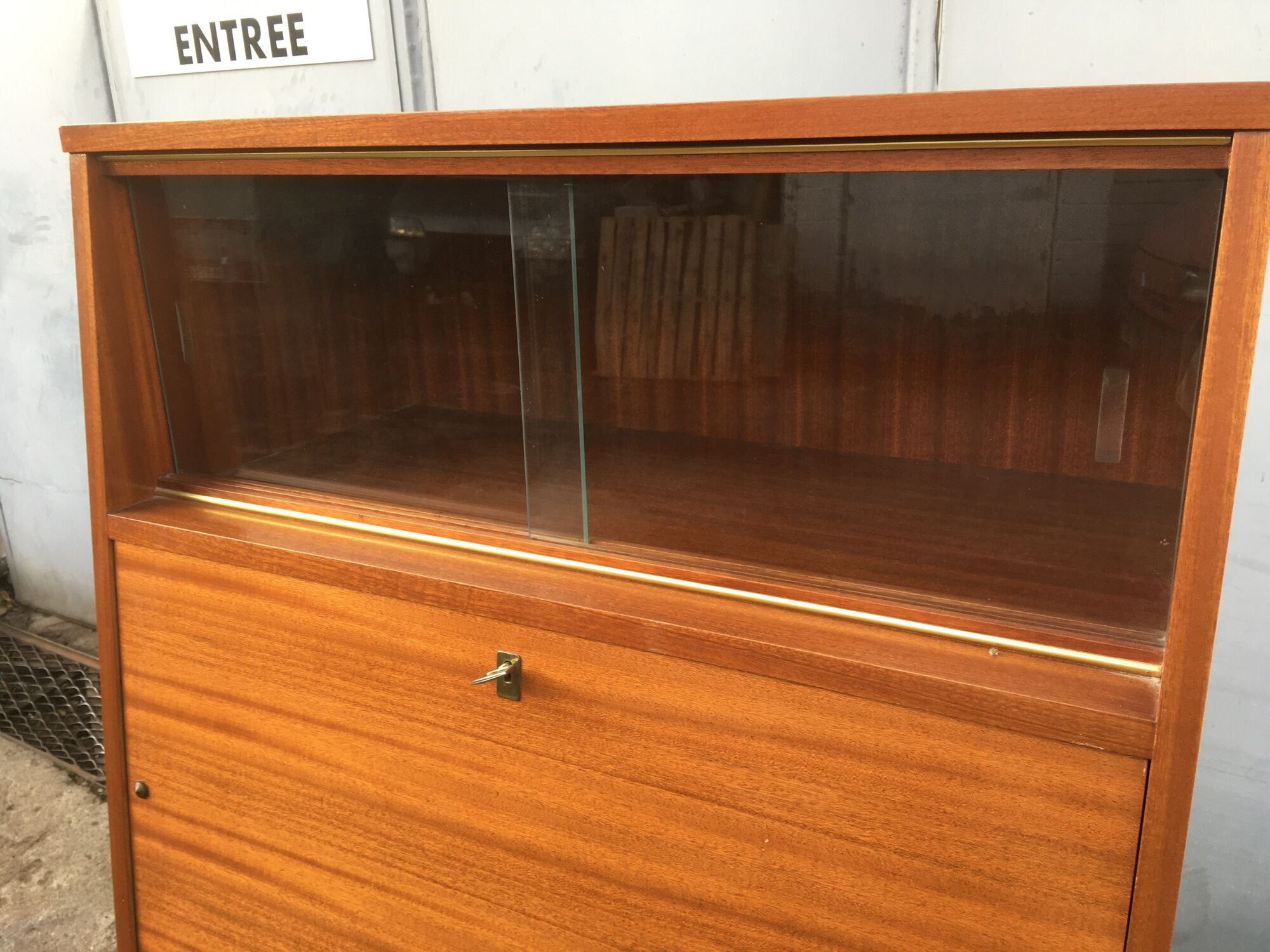 Vintage secretary with wooden compass feet with felling, shop window and closet