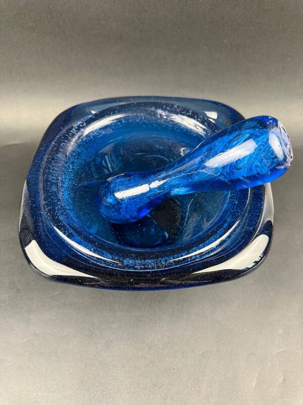 Mortar and pestle in the style of Biot, hard blue.