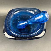 Mortar and pestle in the style of Biot, hard blue.