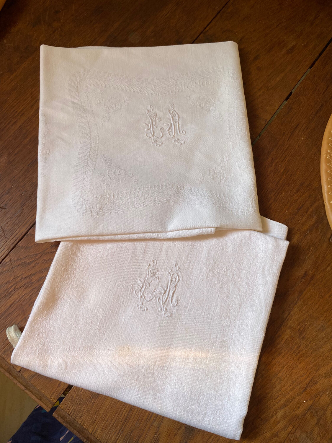 Pair of embroidered white cotton tea towels.