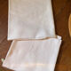 Pair of embroidered white cotton tea towels.