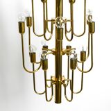 Three staged 18 arm Mid Century brass chandelier with a long brass rod
