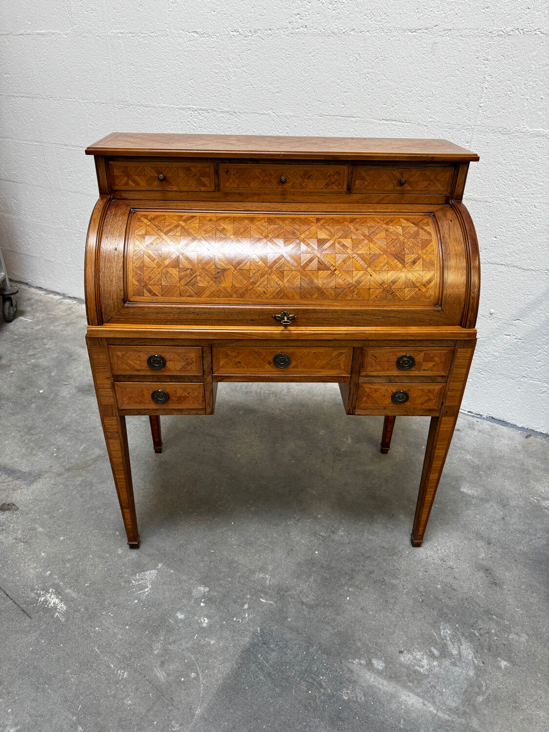 Cylinder desk with marquetry featuring a crosshatch design.
