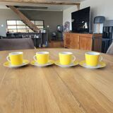 4 yellow and white cups and saucers