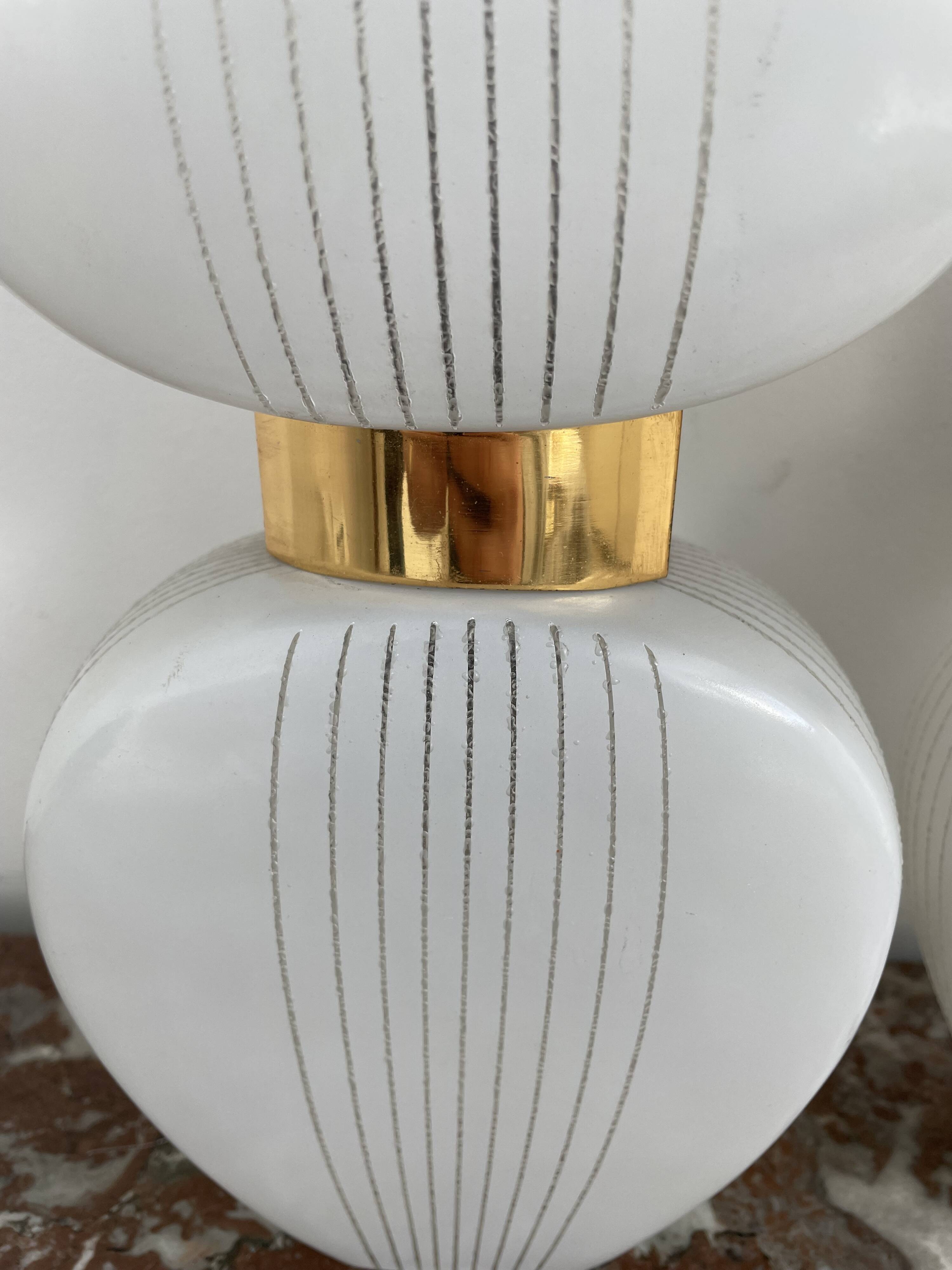 Pair of vintage wall lights from the 60s-70s in striped opaline glass and gilded brass.