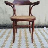 Caned chair with armrests attributed to Fischel