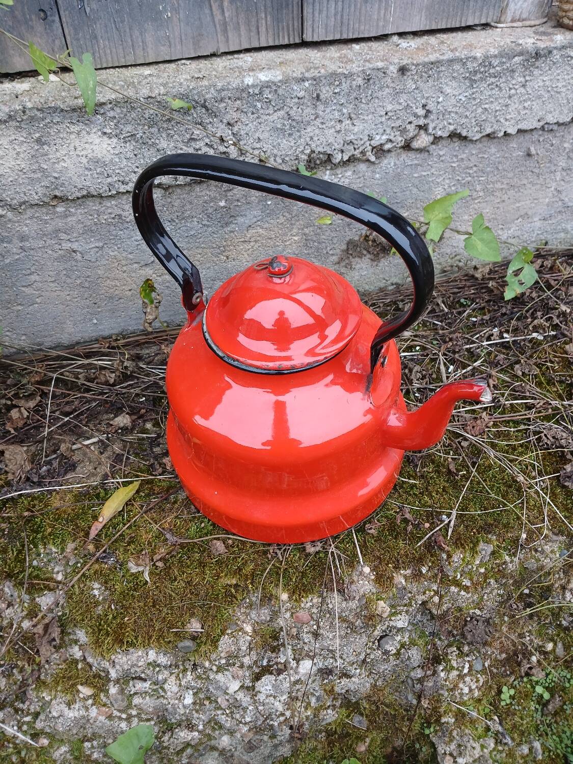 Antique teapot in red enamelled sheet metal