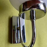Pair of chrome metal wall lights with white glass globe.